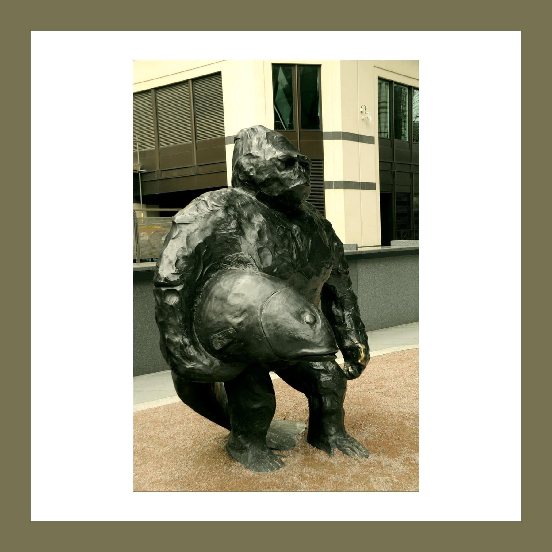 Bronze sculpture of a gorilla displayed outdoors among City of London buildings