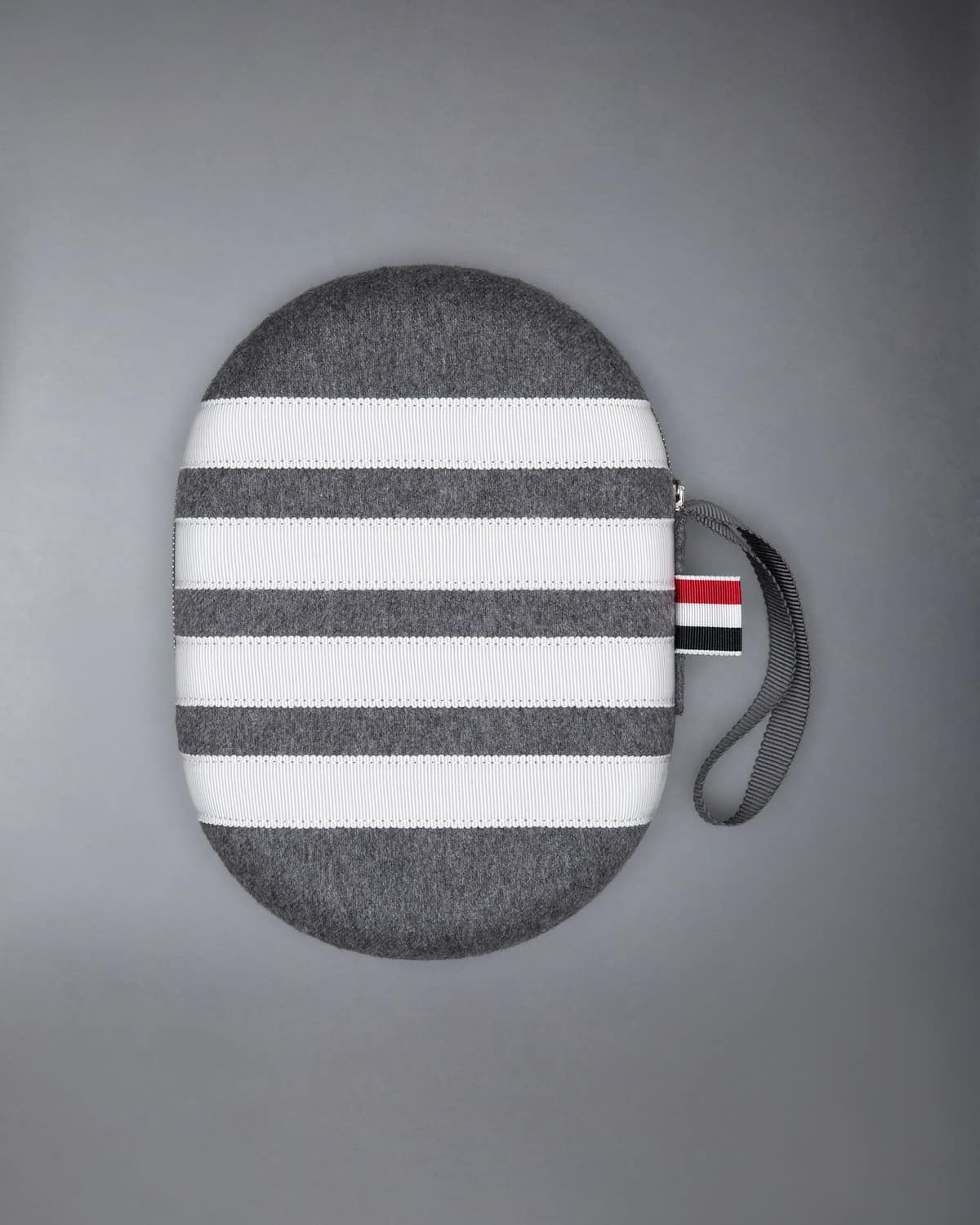 Grey cashmere headphone case with four white stripes, a grosgrain tab and a wrist strap