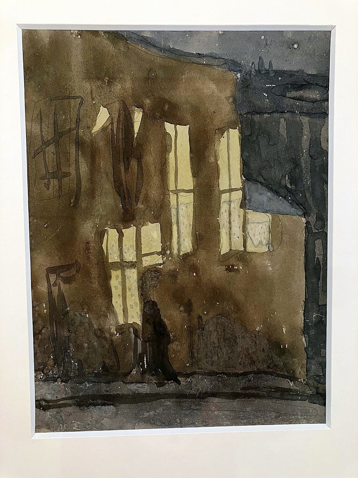 Gwen John watercolour of a brown street facade with lit windows and a dark figure passing below