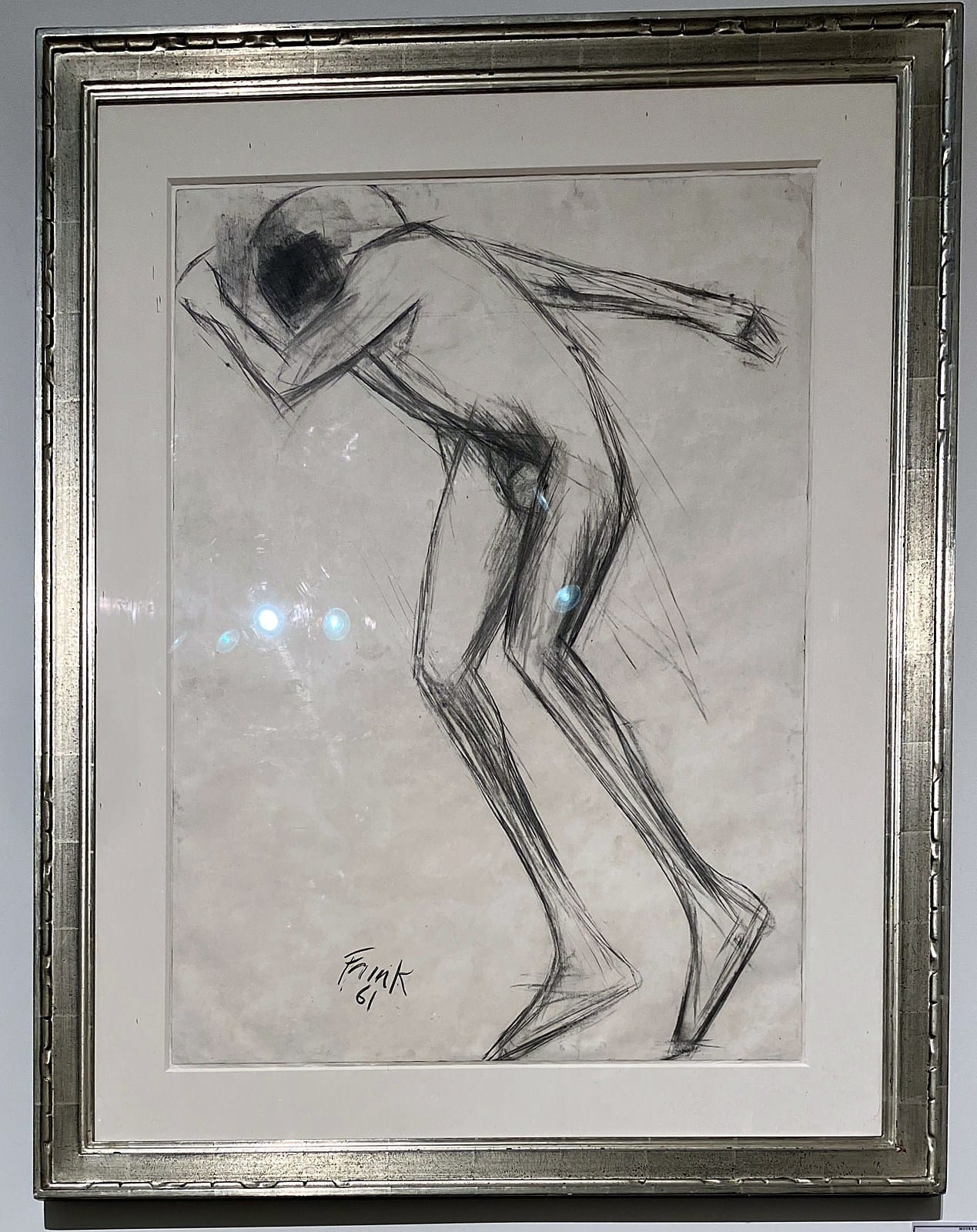 Elisabeth Frink charcoal of a thin figure leaning forward with one arm over his head, in a silver frame
