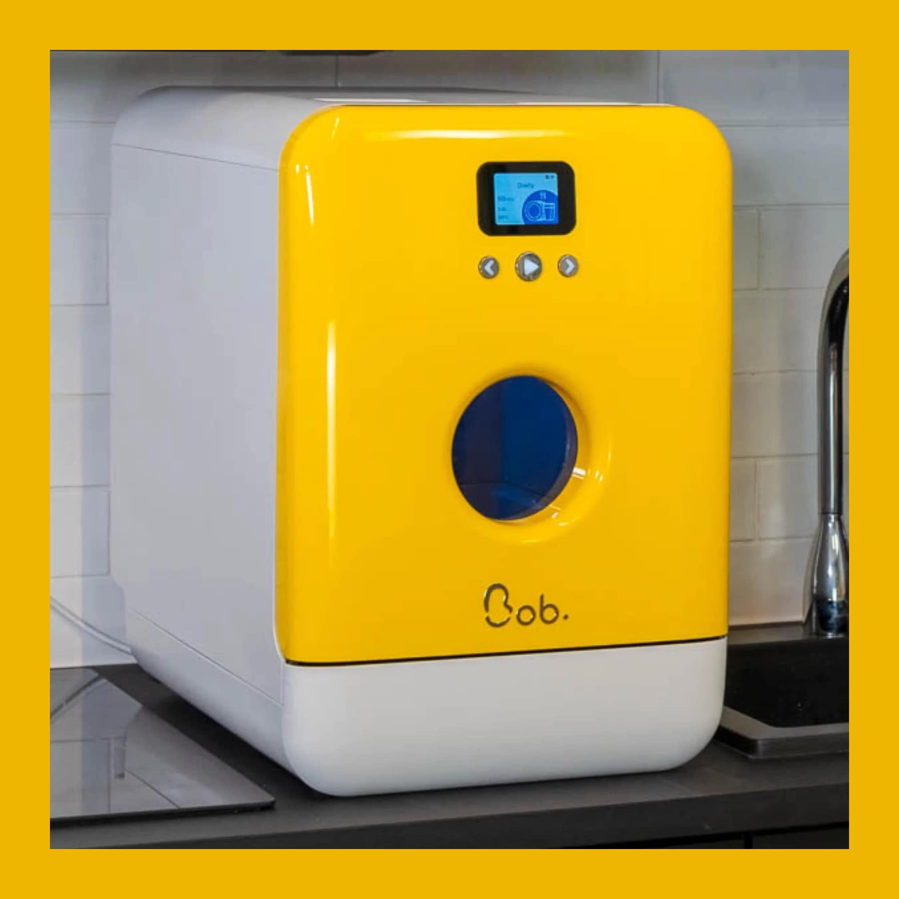 Bob compact countertop dishwasher with a yellow door and round window, on a kitchen worktop beside the sink