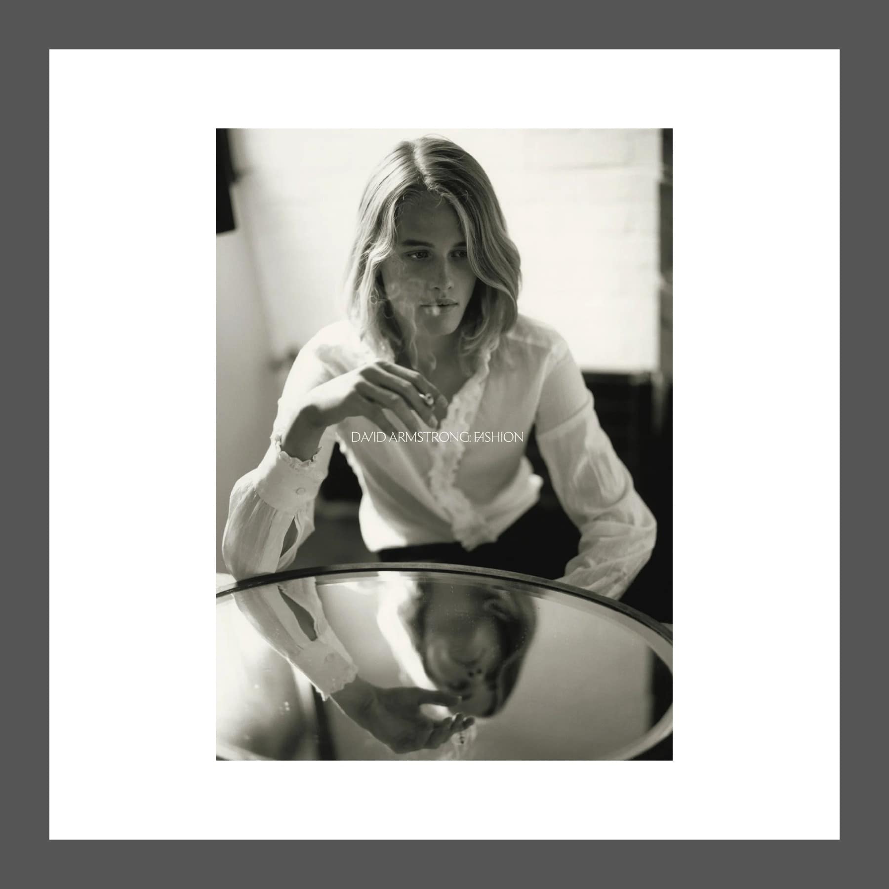 Cover of David Armstrong: Fashion from MATTE, a black and white photograph of a model at a mirrored table