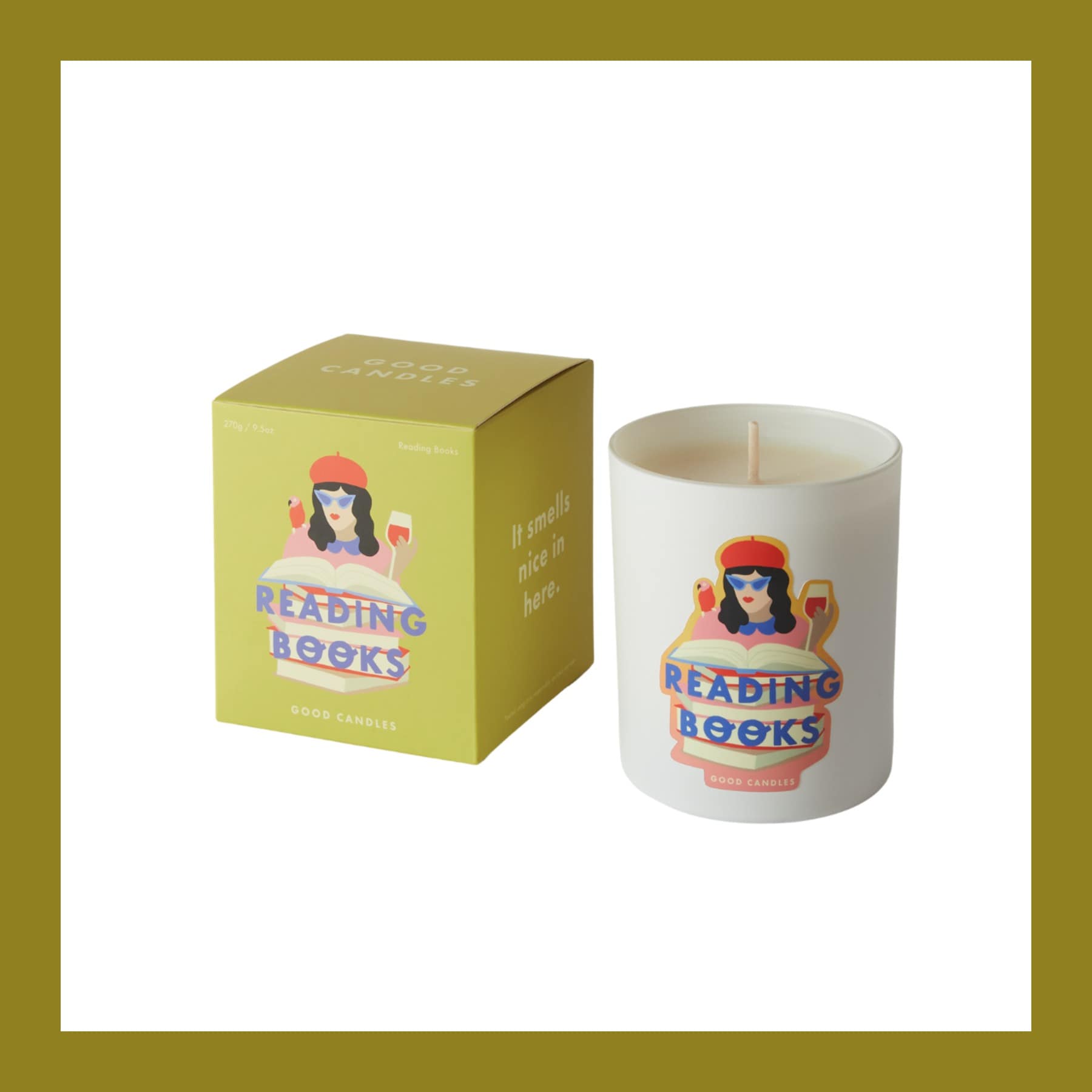 Good Candles Reading Books candle in a white glass with its olive green illustrated box