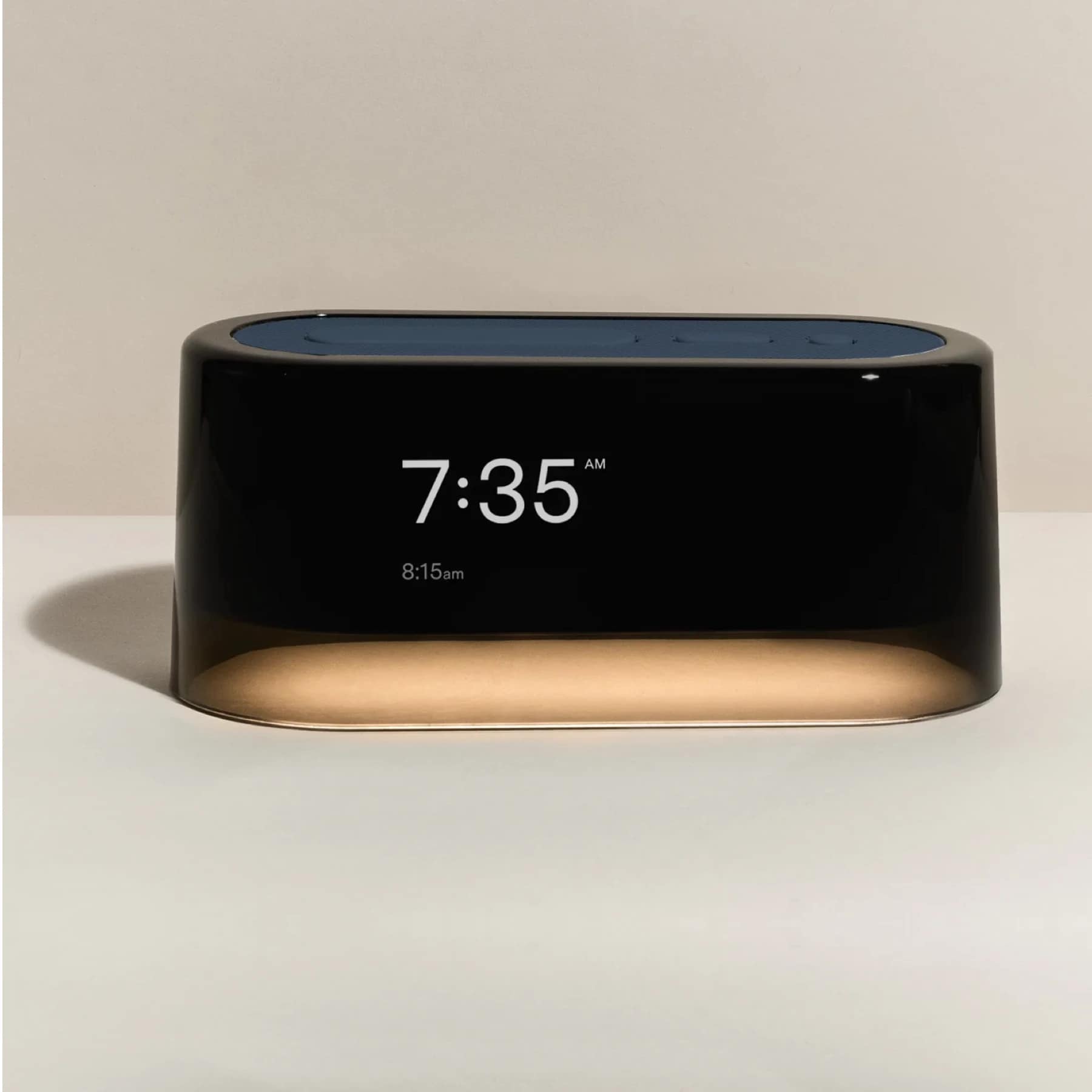 Loftie Alarm Clock displaying 7:35 AM with a sleek black and gold design on a neutral background
