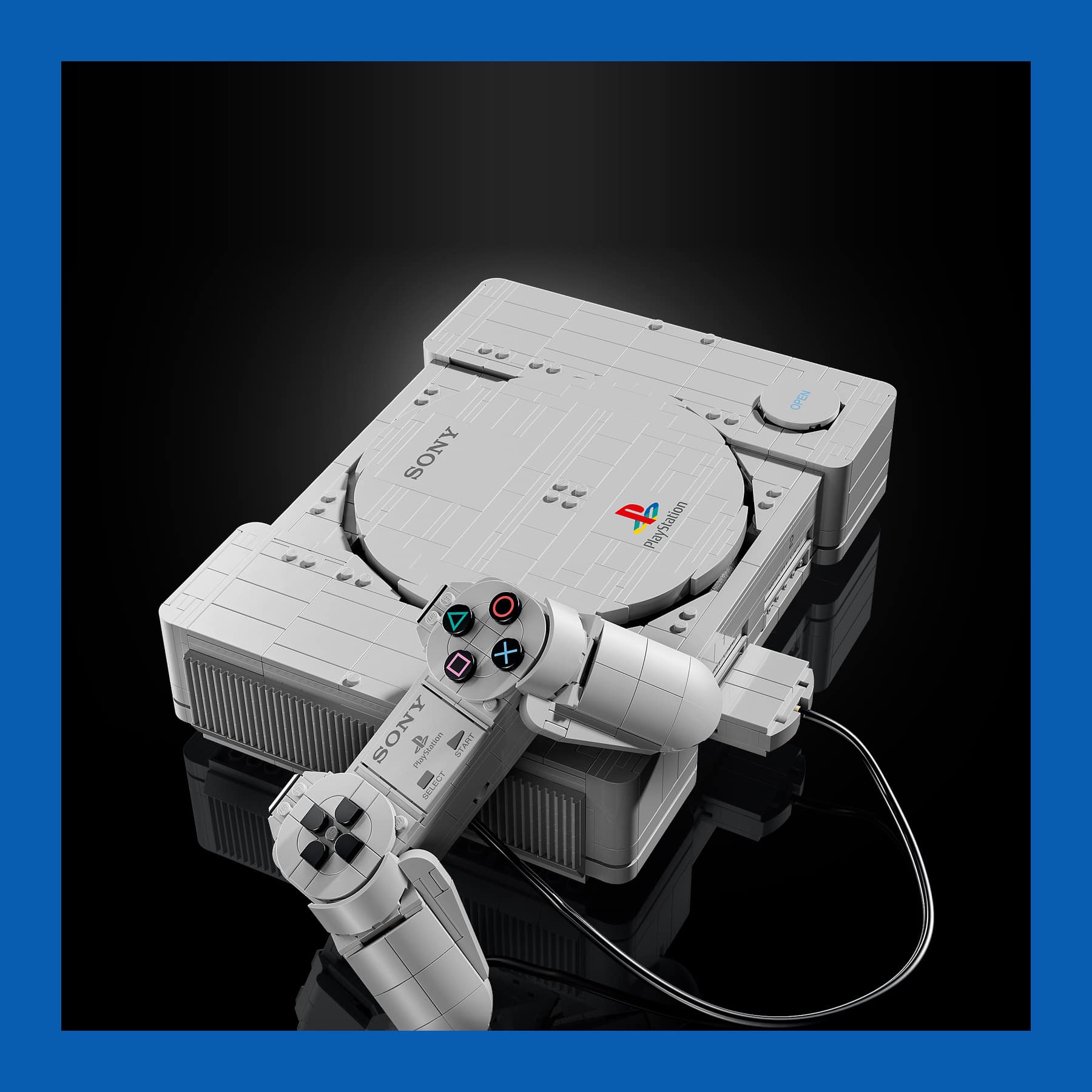 LEGO PlayStation 72306 brick model of the original grey console with the controller plugged into the front