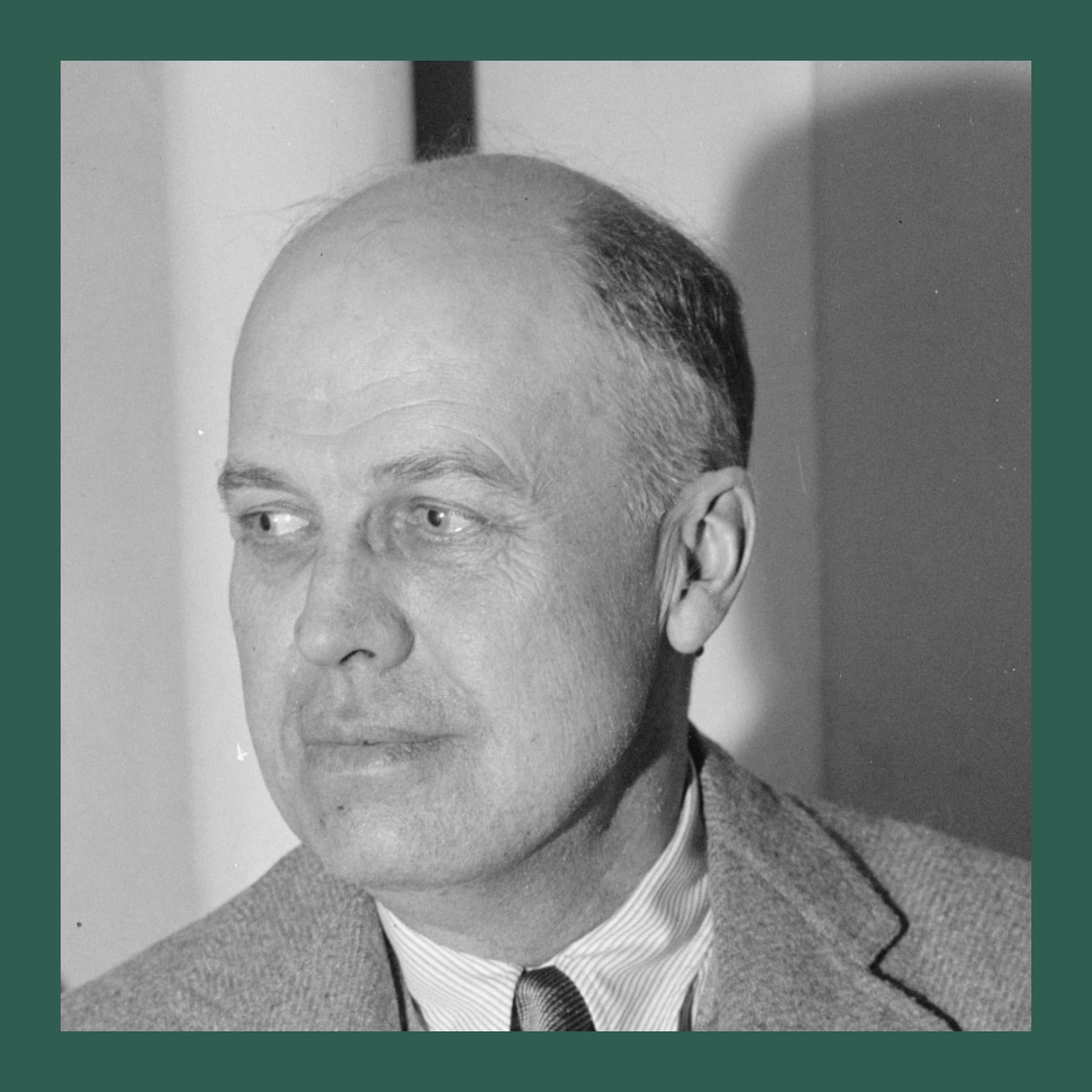 Black and white photograph of Edward Hopper in a tweed jacket and tie, looking to one side