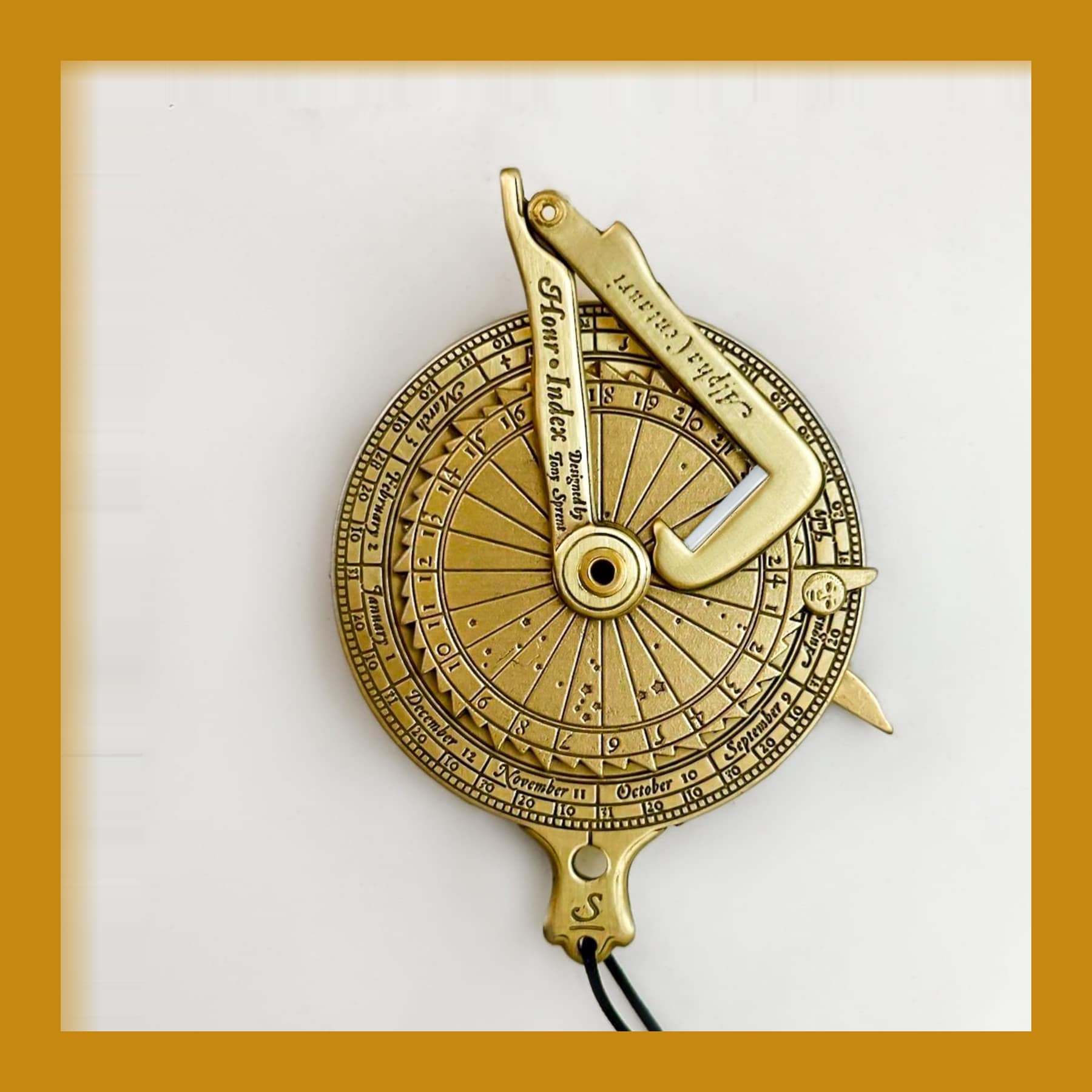 Solid brass Kala Universal Pocket Nocturnal, a 60mm engraved disc with a pivoting arm and a cord