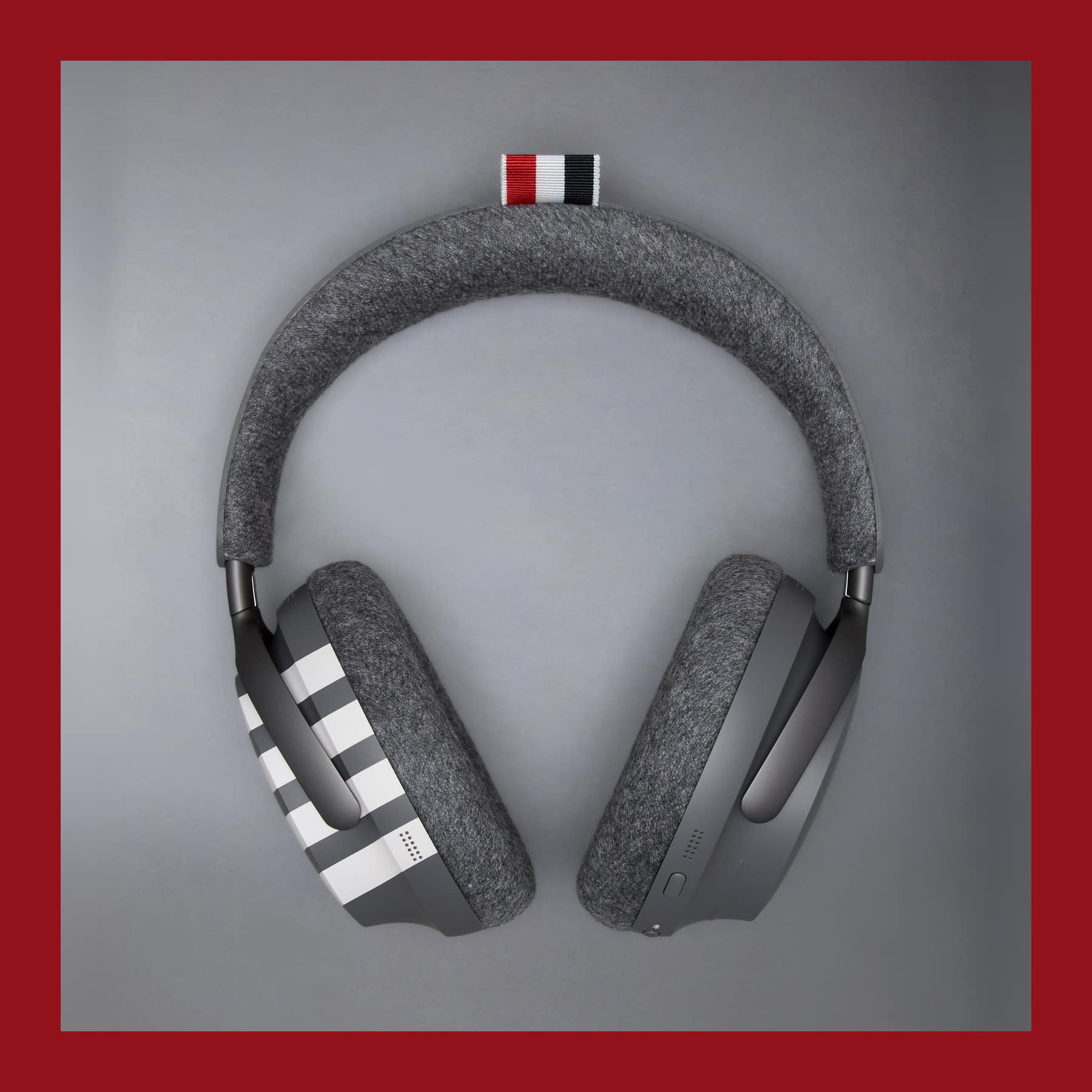 Bose Thom Browne headphones with a grey cashmere headband, four-bar striped earcup and red, white and blue grosgrain tab