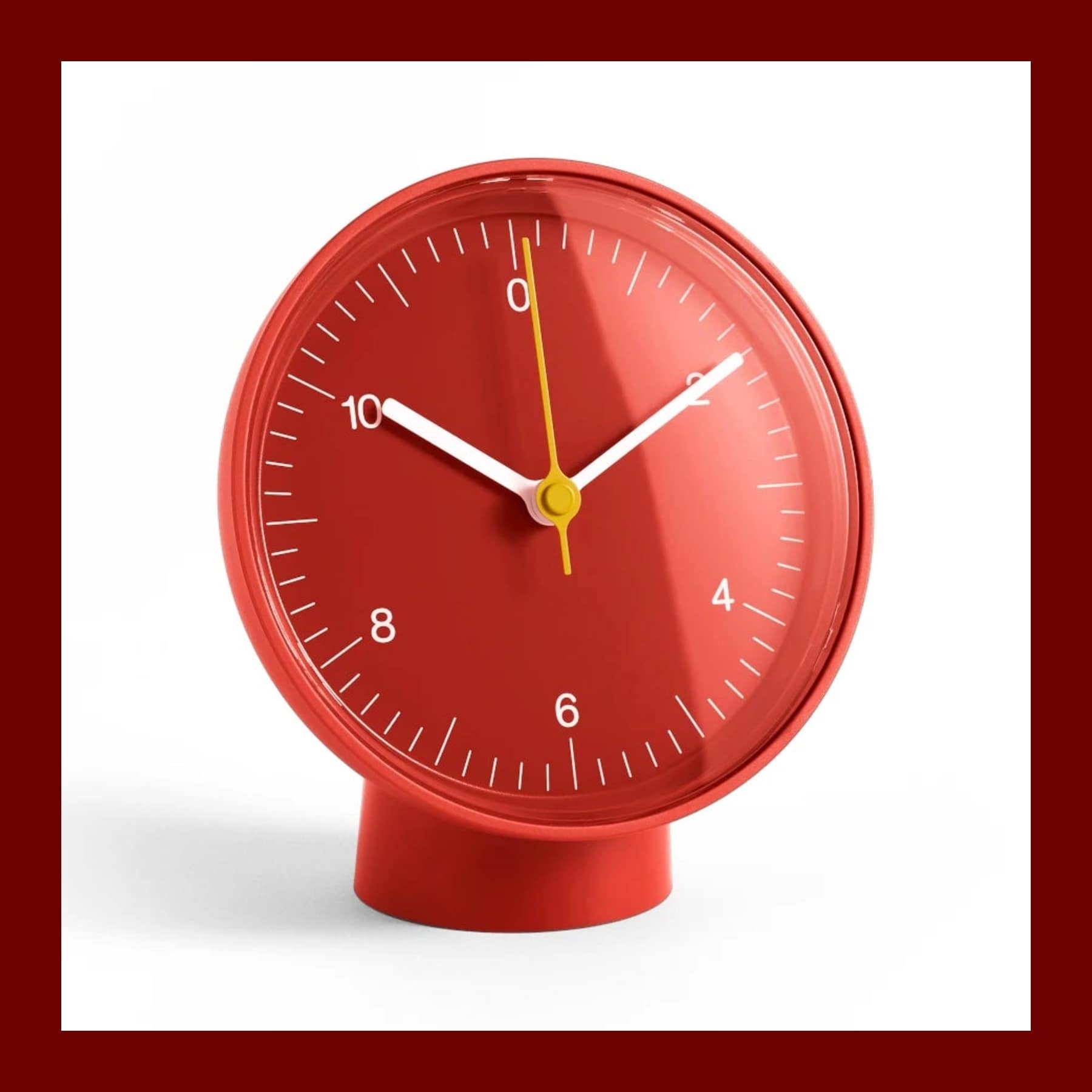 Red Jasper Morrison table clock for HAY on a cylindrical foot, with a yellow second hand
