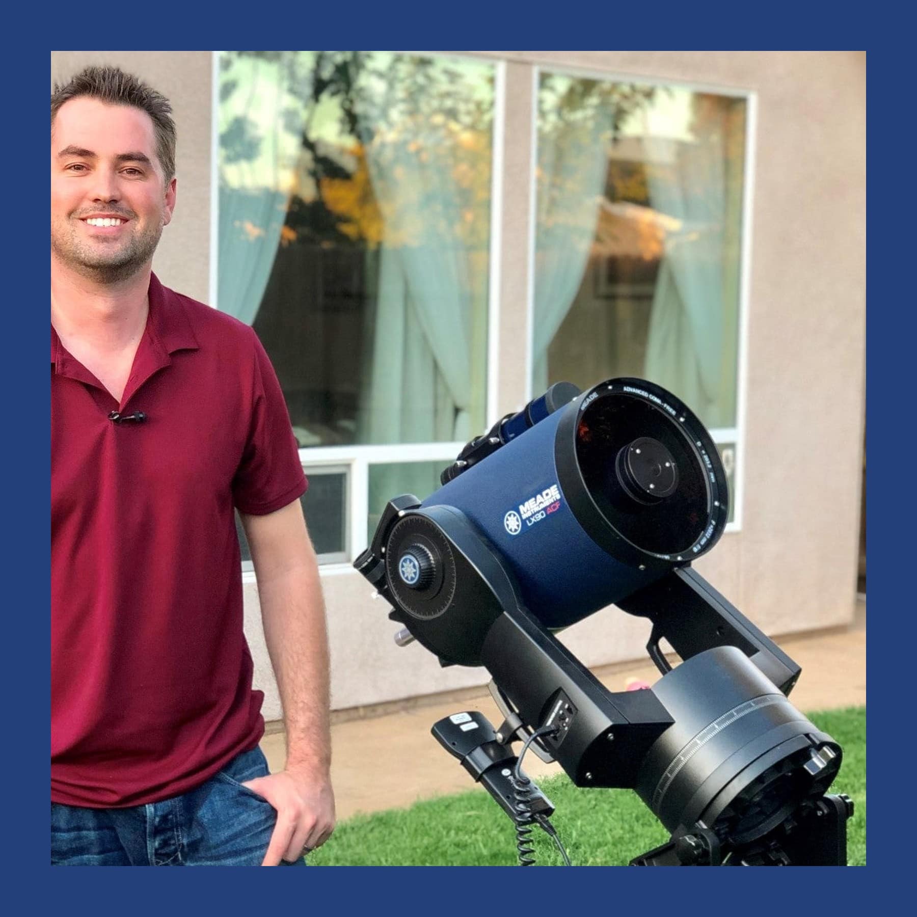 Andrew McCarthy in a red polo shirt standing beside a large blue telescope in a back garden