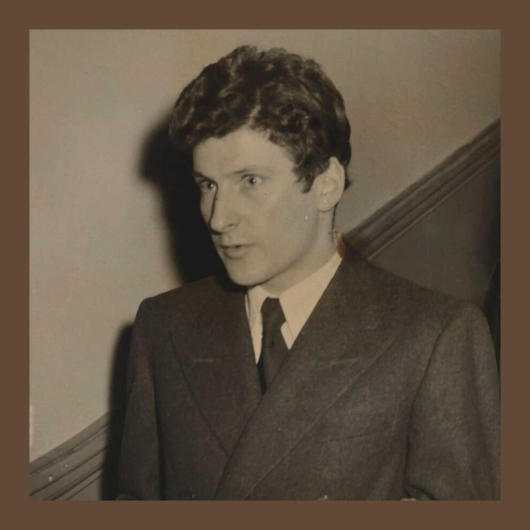 Black and white photograph of a young Lucian Freud in a double-breasted suit, 1953