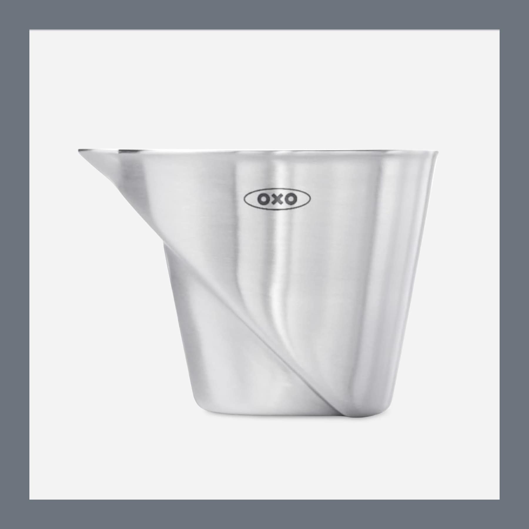 OXO Steel angled measuring jigger in brushed stainless steel, showing the internal ramp that carries the measurement markings