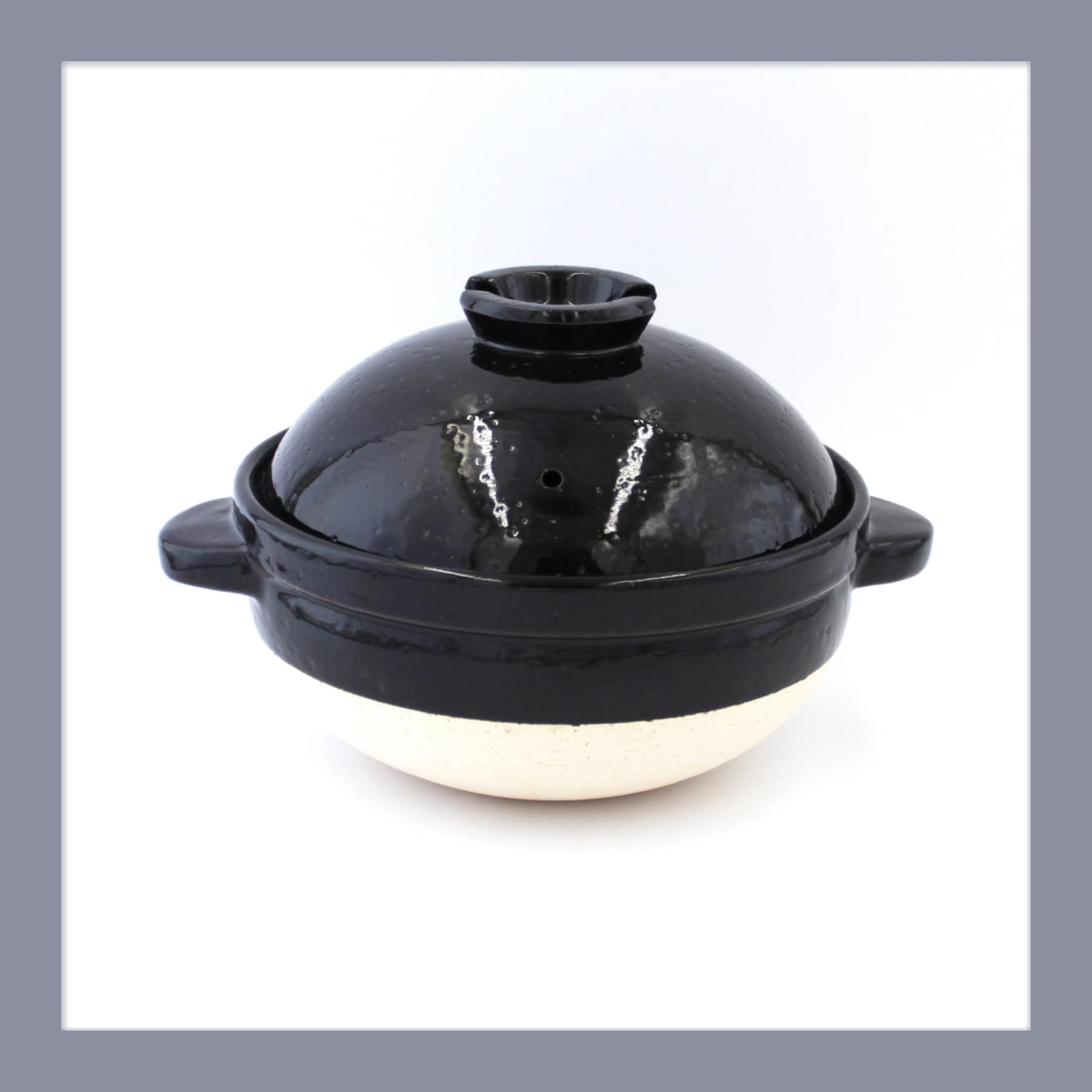 Kamado-san donabe clay rice cooker with a black glazed domed lid and pale unglazed base