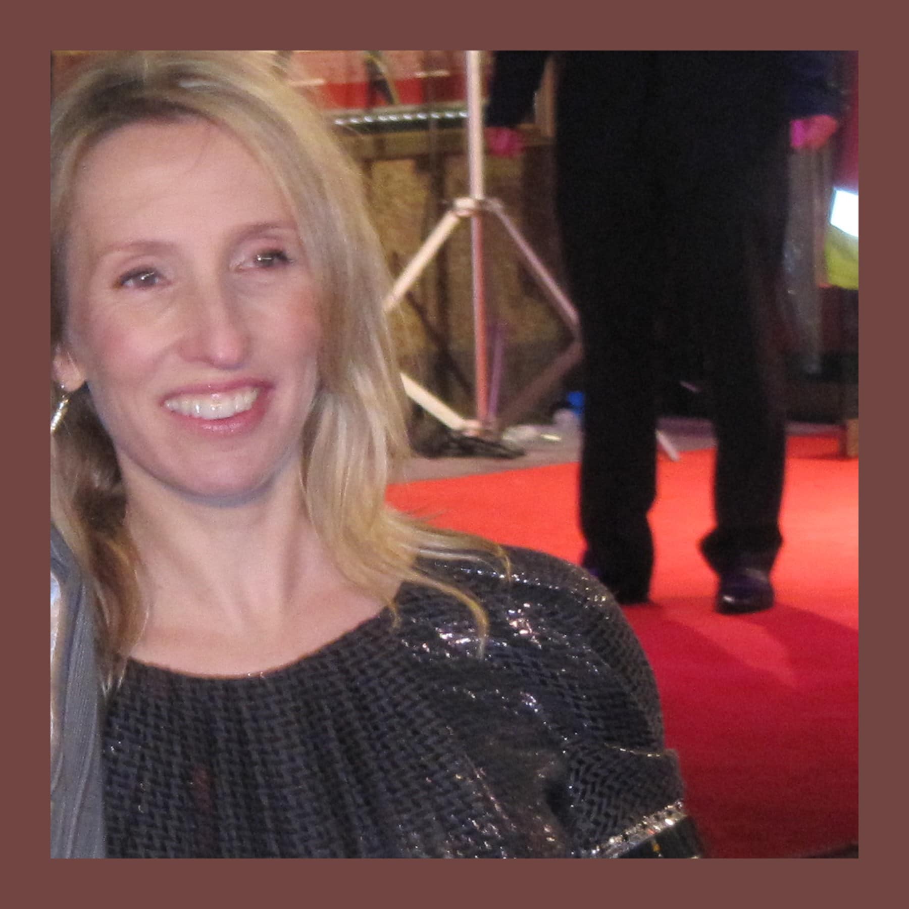 Sam Taylor-Johnson smiling on a red carpet