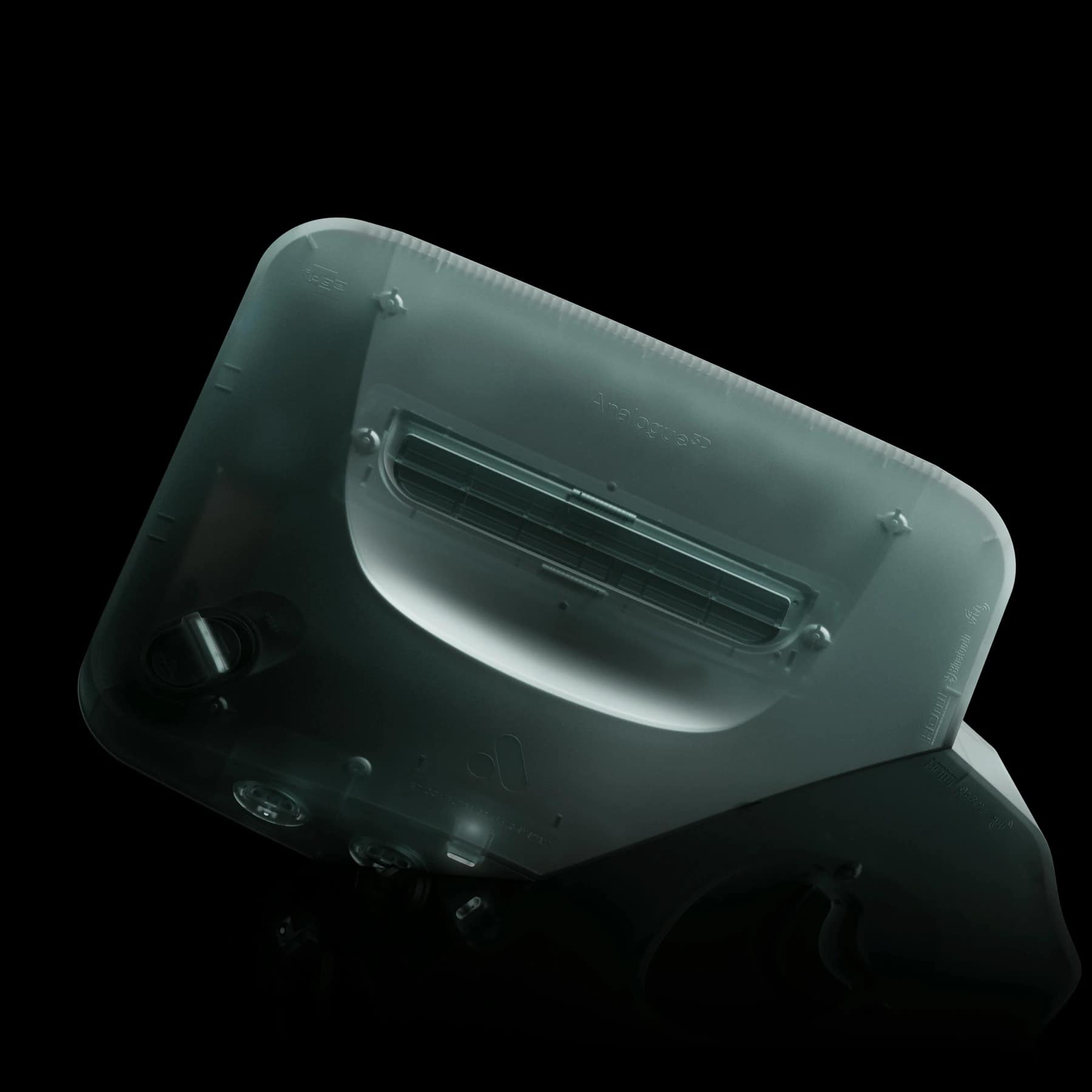 view of the translucent Analogue 3D Ghost limited edition console showing the cartridge slot and ports against a black background.