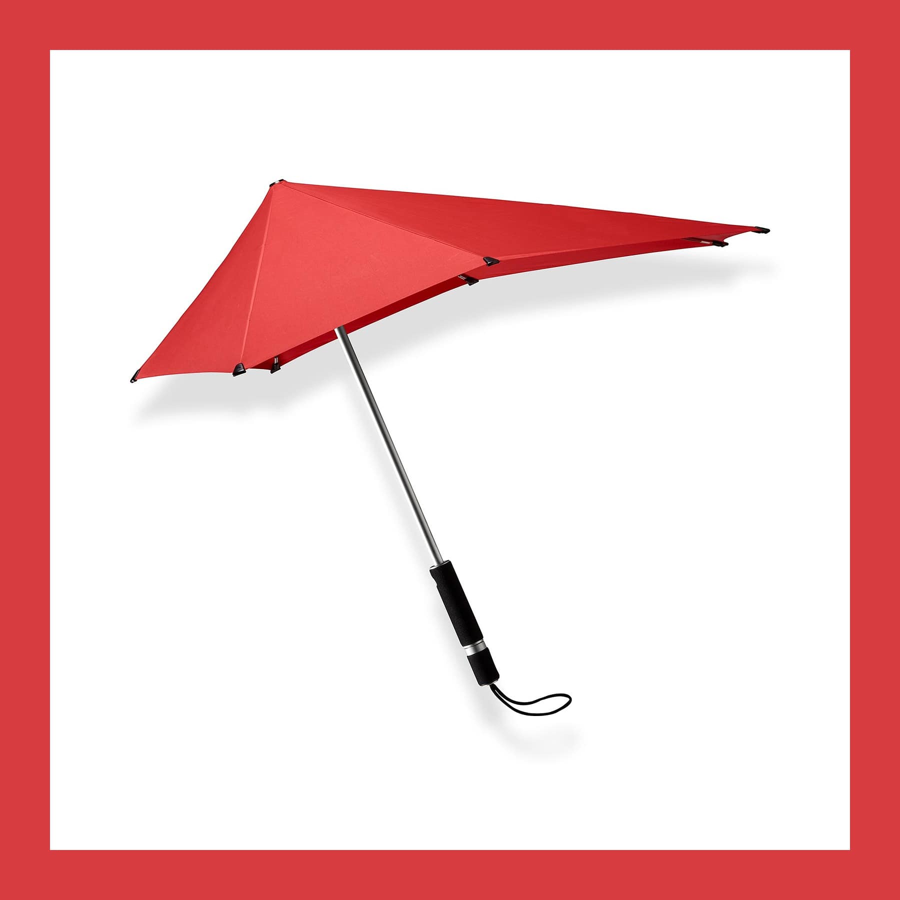 Red Senz Original storm umbrella open, with its lopsided canopy, aluminium shaft and black foam handle