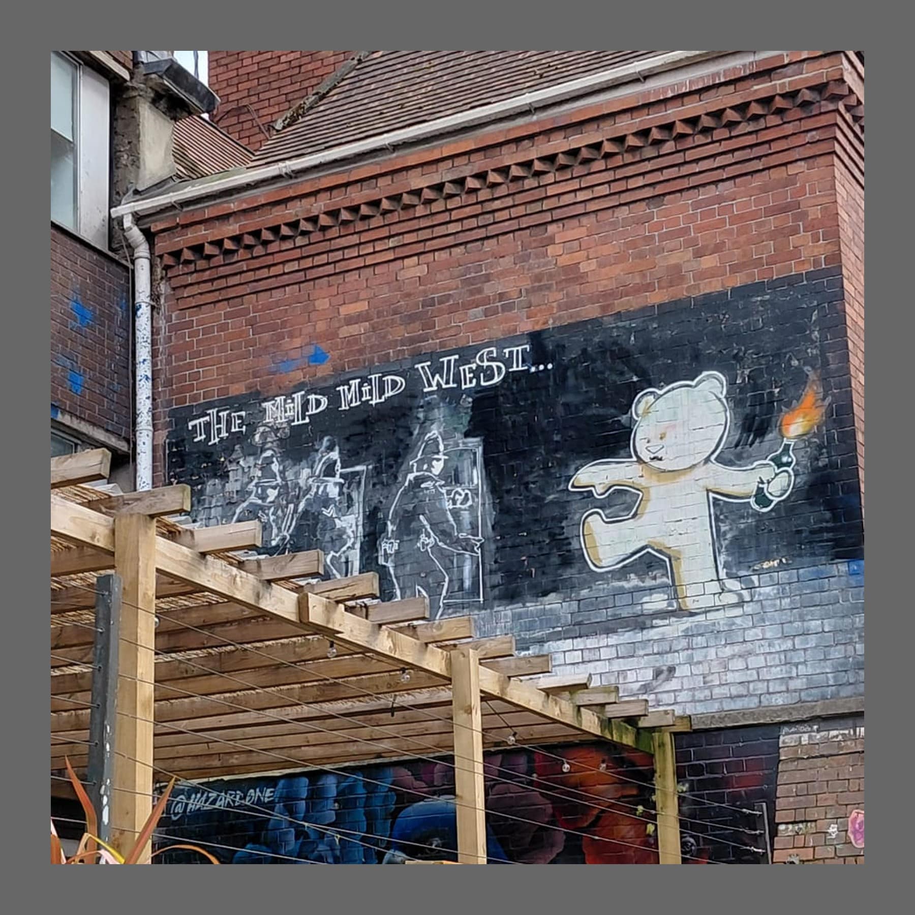 Banksy mural of a teddy bear throwing a Molotov cocktail at riot police, Stokes Croft, Bristol