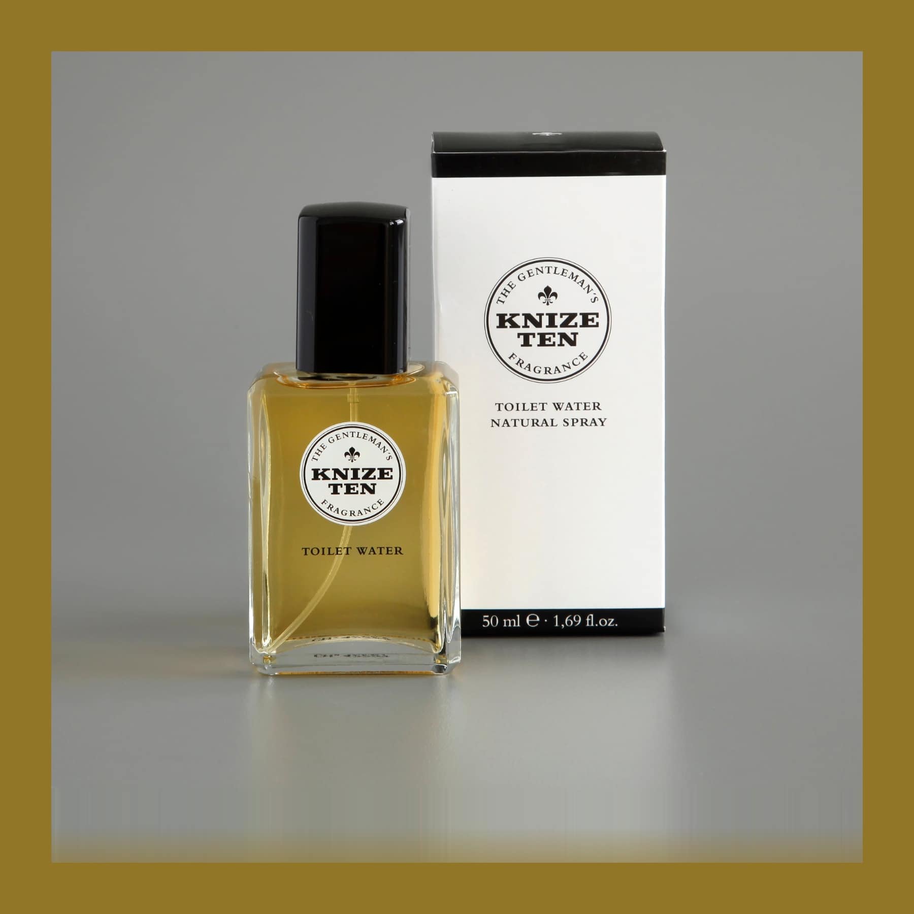 Knize Ten toilet water bottle in amber glass beside its white printed box