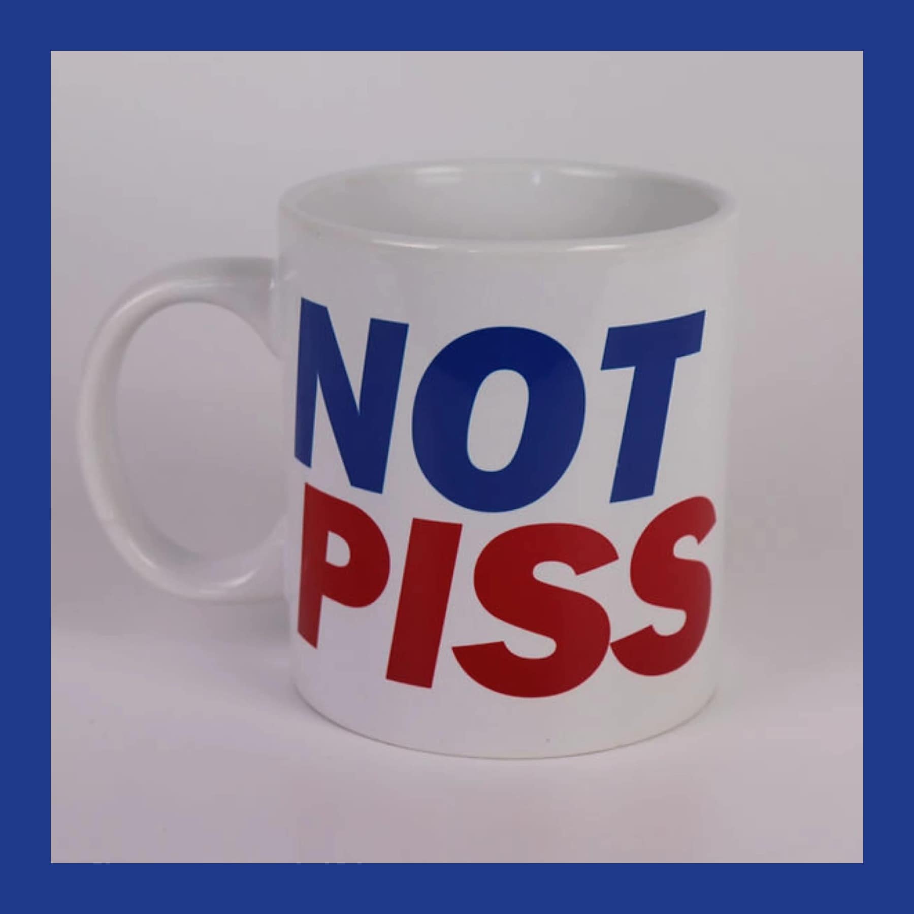 White pint-size mug printed with NOT PISS in large blue and red capital letters
