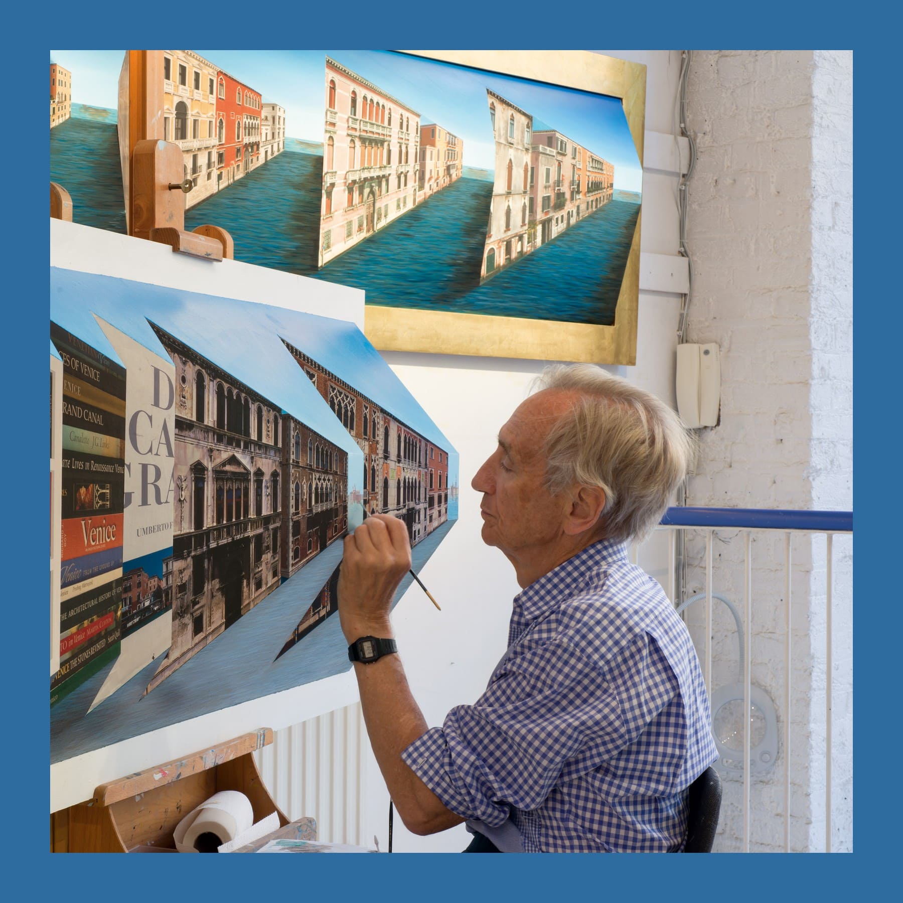 Patrick Hughes painting a Venice reverspective in his studio, with more reliefs on the wall behind
