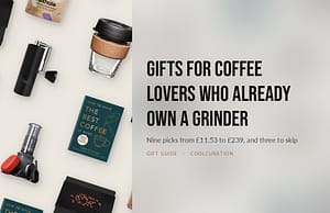 Flat lay of coffee gifts including a hand grinder, a reusable cup, an AeroPress, a bag of beans and a coffee book