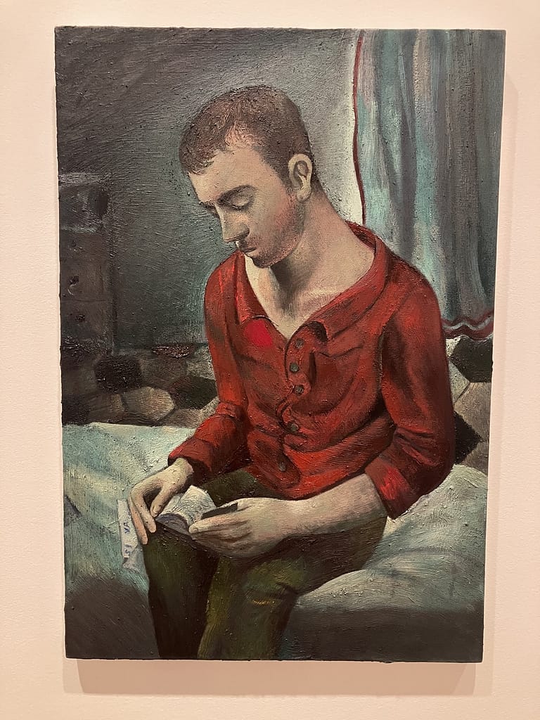 Louis Fratino painting of a young man in a red shirt reading on a bed