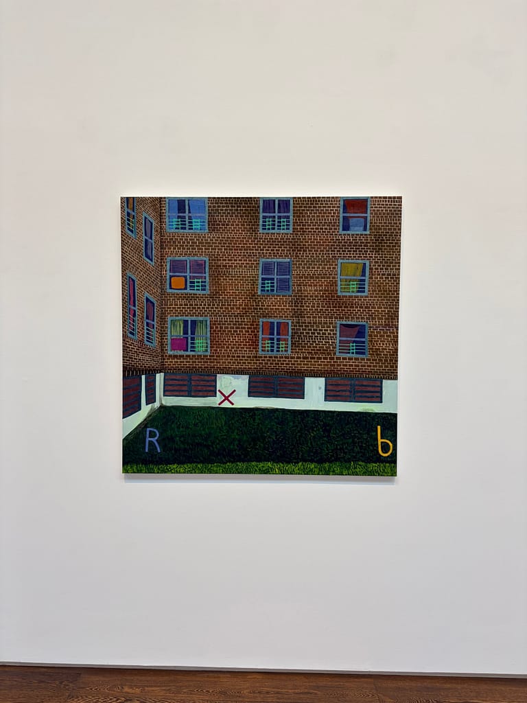 Square painting of a brick housing block and a hedge, with the letters R and b painted on the surface
