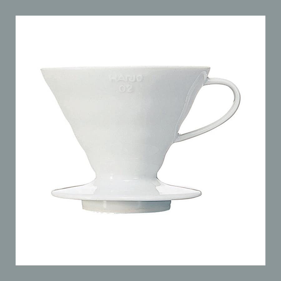Hario V60 size 02 pour over dripper in white ceramic, shown from the side with its spiral ribs