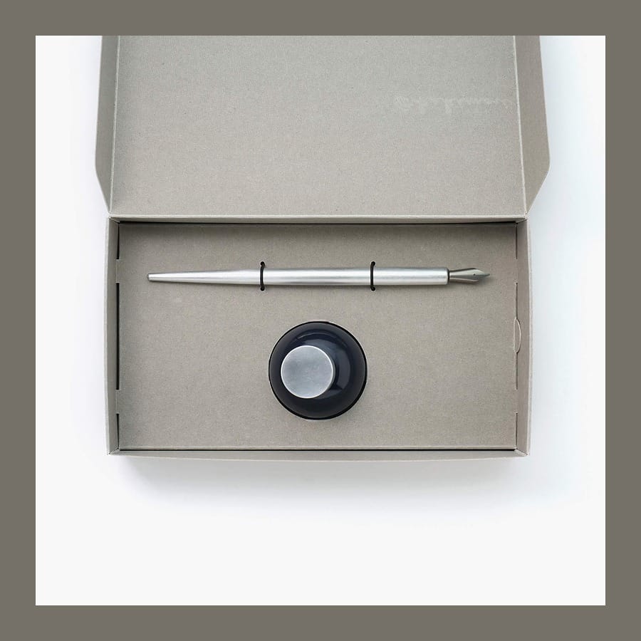 Open Kakimori gift box with an aluminium nib holder and a bottle of pigment ink