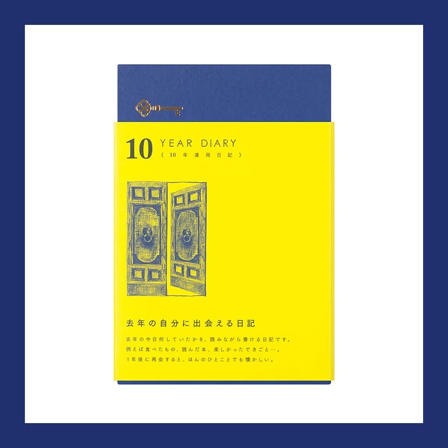 Midori 10 Year Diary in its yellow paper sleeve over a navy cloth cover