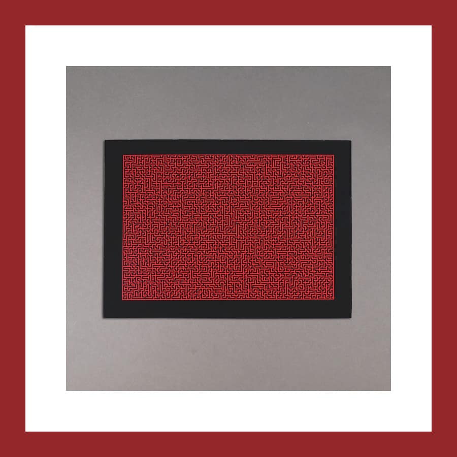 Foka Wolf Impossible Maze print, a dense red maze pattern on a black field, photographed on a grey ground