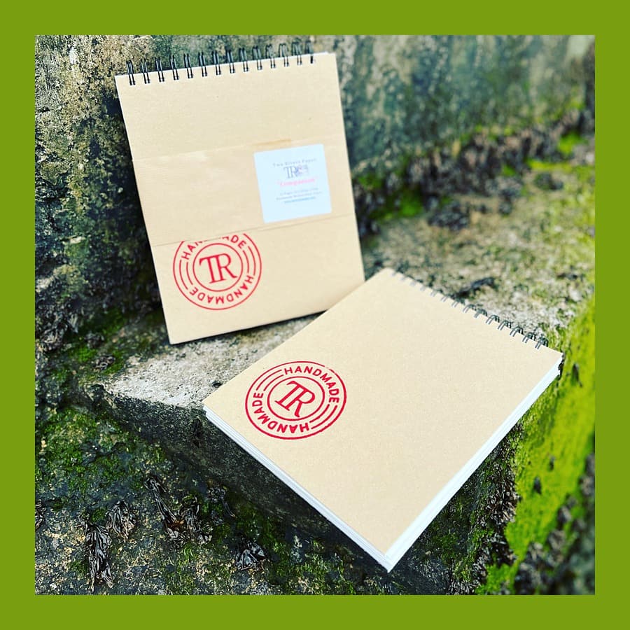 Two Rivers Paper Companion spiral sketch pads with red Handmade stamps on mossy stone