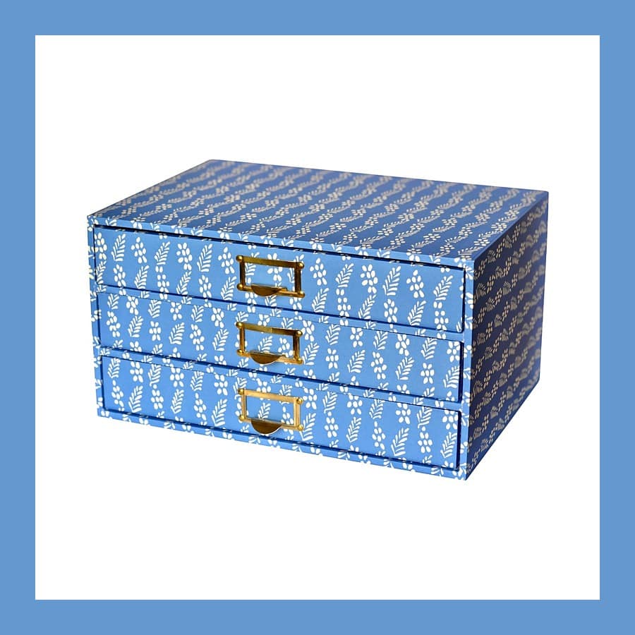 Three blue Cambridge Imprint collector's drawers in Enid Marx Necktie paper with brass pulls
