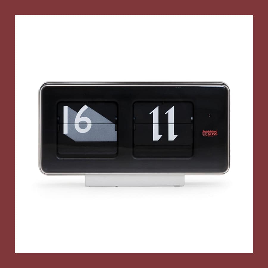 Established and Sons Font Clock by Sebastian Wrong, a black flip clock showing 16 11 in two typefaces