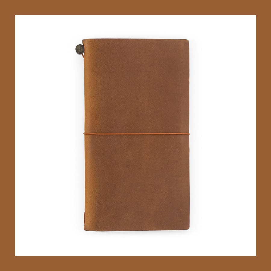 Camel brown leather Traveler's notebook closed with its elastic band