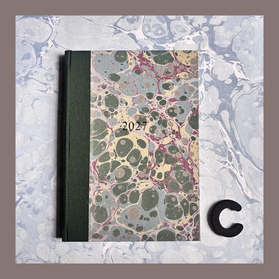 Compton Marbling 2027 A5 diary with a green cloth spine and marbled cover