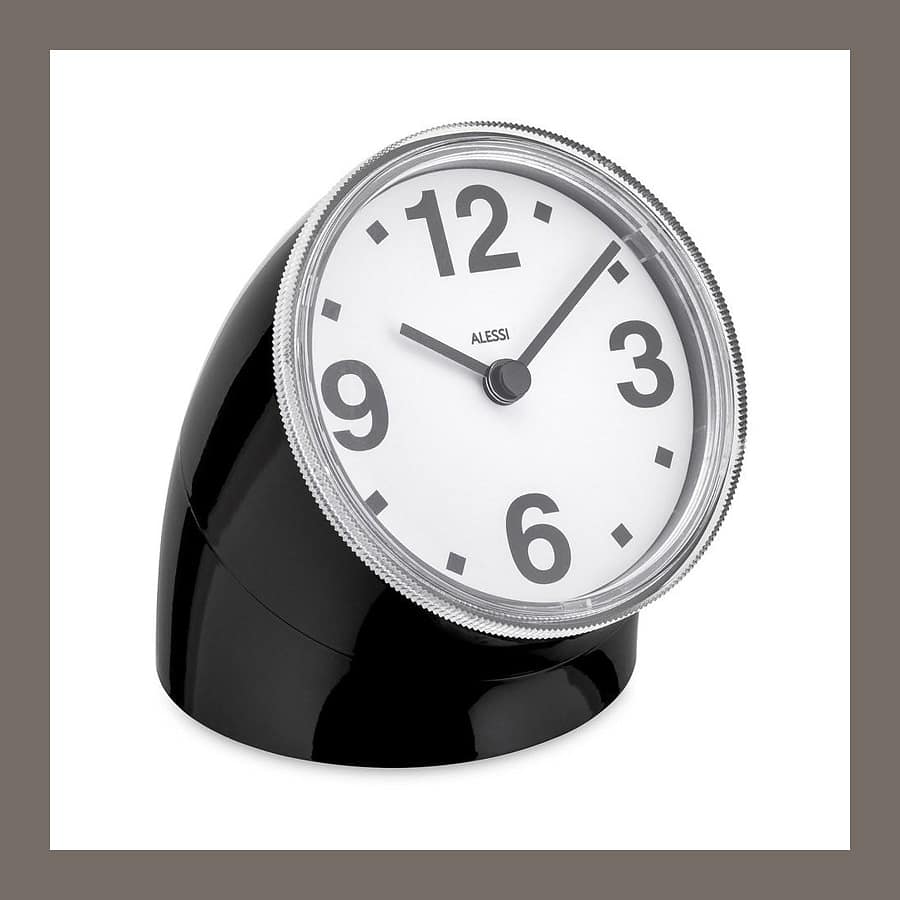 Alessi Cronotime desk clock by Pio Manzรน, a black cylinder with a tilted white clock face