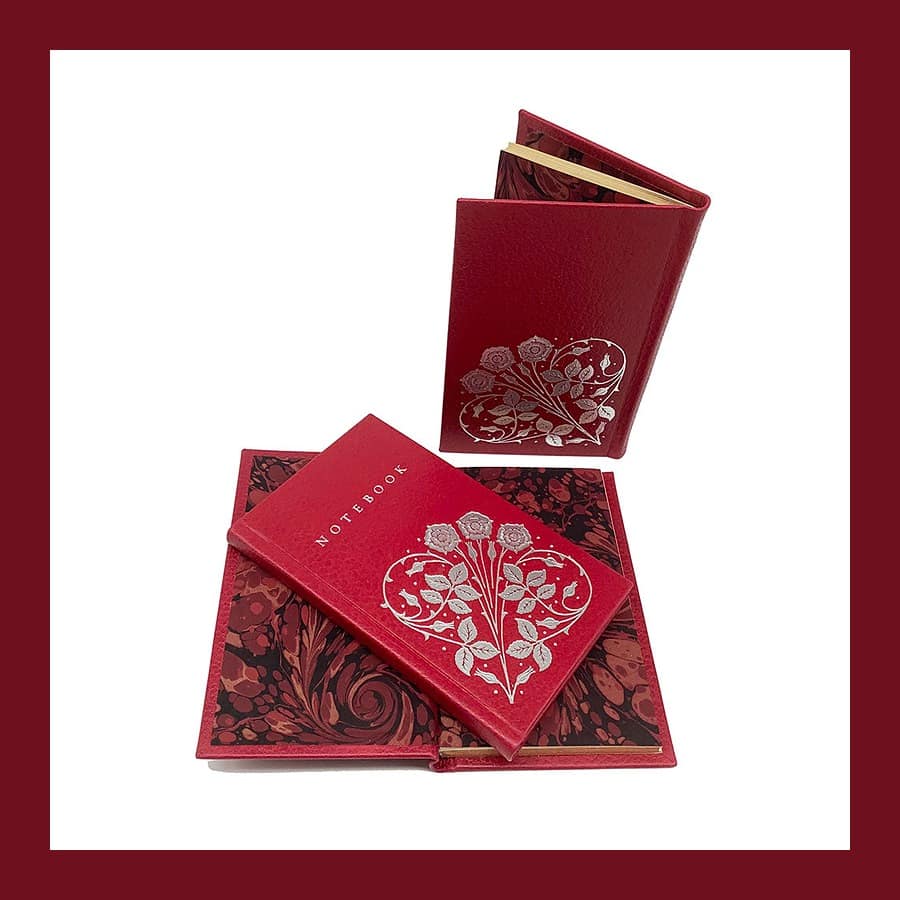 Red leather Sangorski notebooks from Shepherds with silver blocking and marbled endpapers