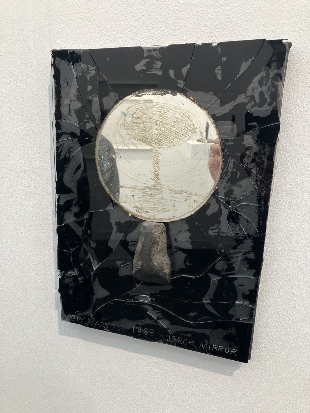 Derek Jarman Mirror Mirror, a black glossy panel with a round mirror