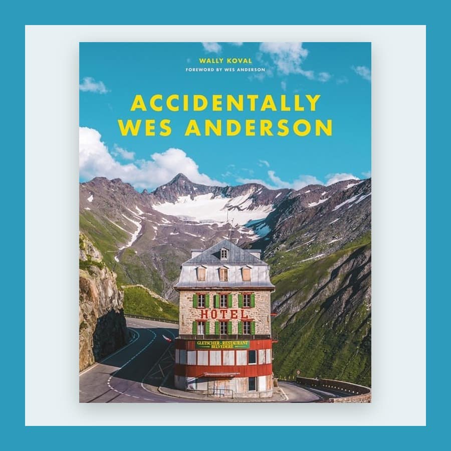 Cover of Accidentally Wes Anderson showing a pink hotel below mountains, in a blue frame