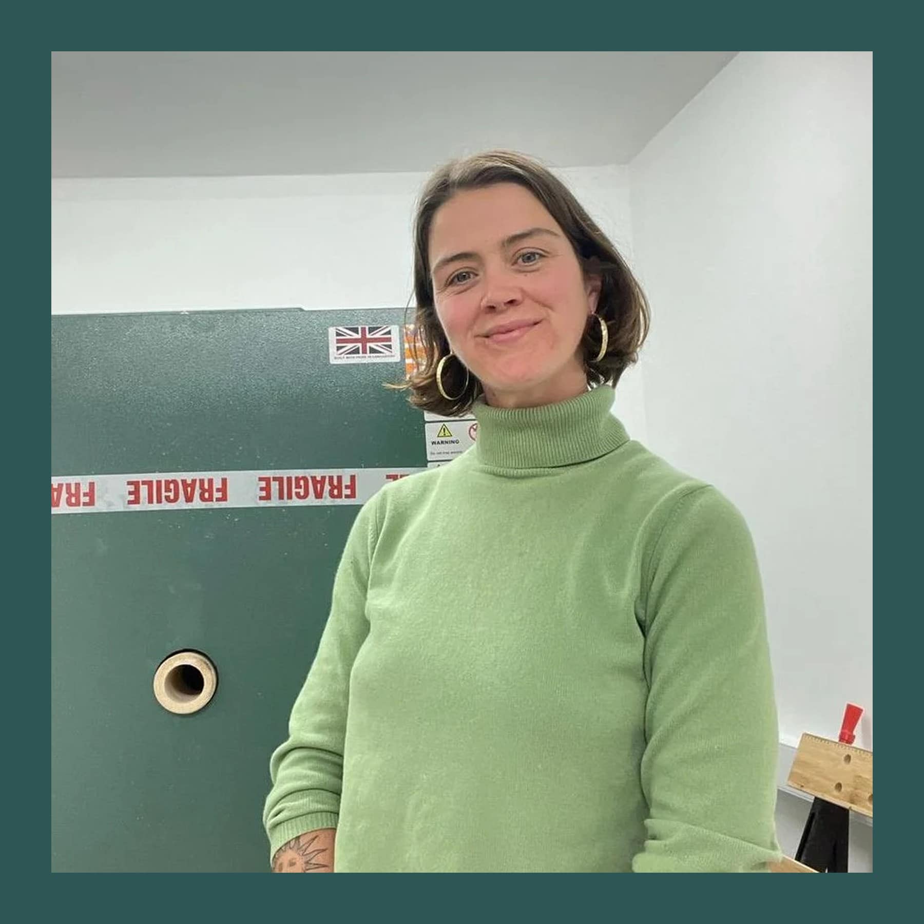 Mercedes Lucy in a green polo-neck jumper and gold hoop earrings at TKE Studios in Margate