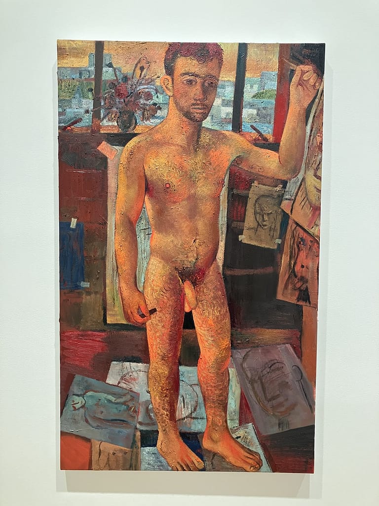 Louis Fratino nude self-portrait standing in a red studio with drawings pinned to the wall