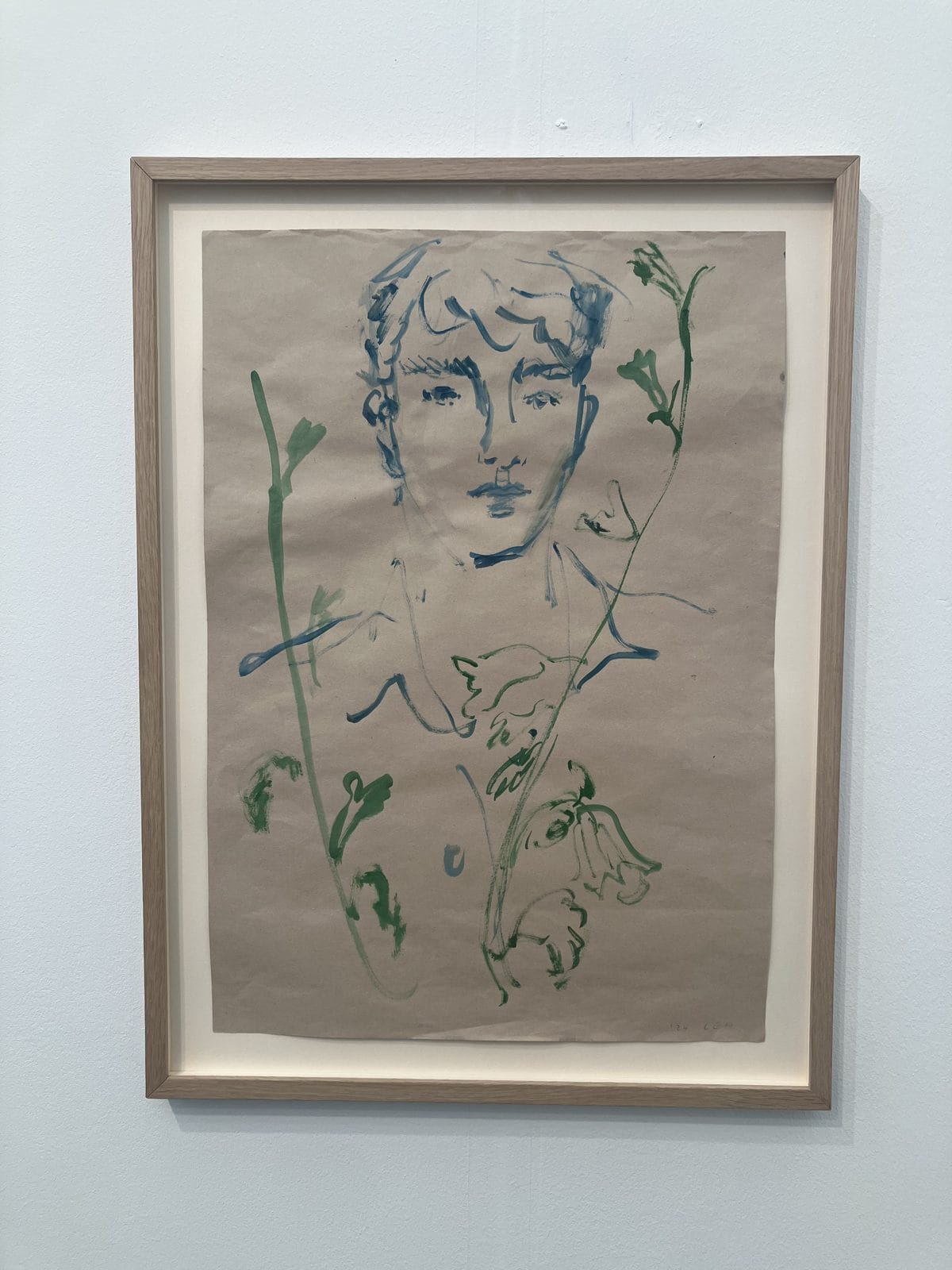 Luke Edward Hall watercolour of a young man among green stems on brown paper
