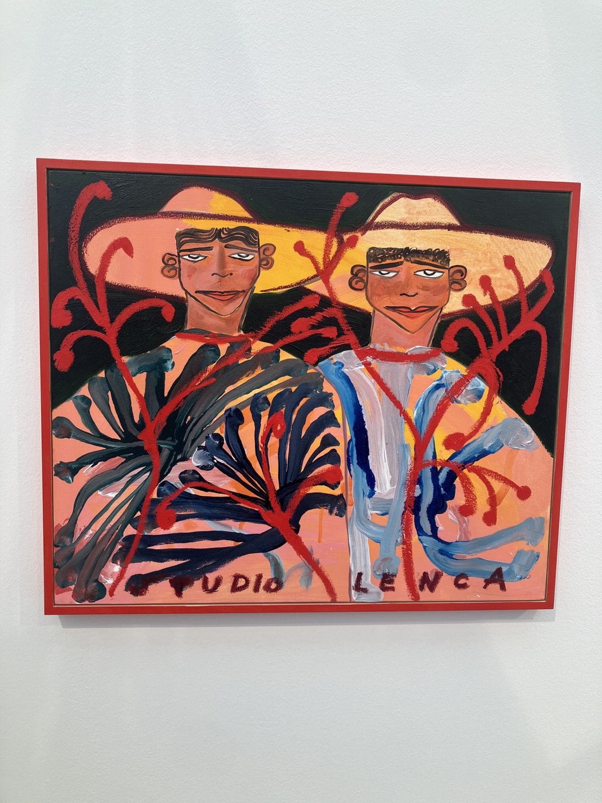 Studio Lenca painting of two men in sombreros on an orange ground with red vines