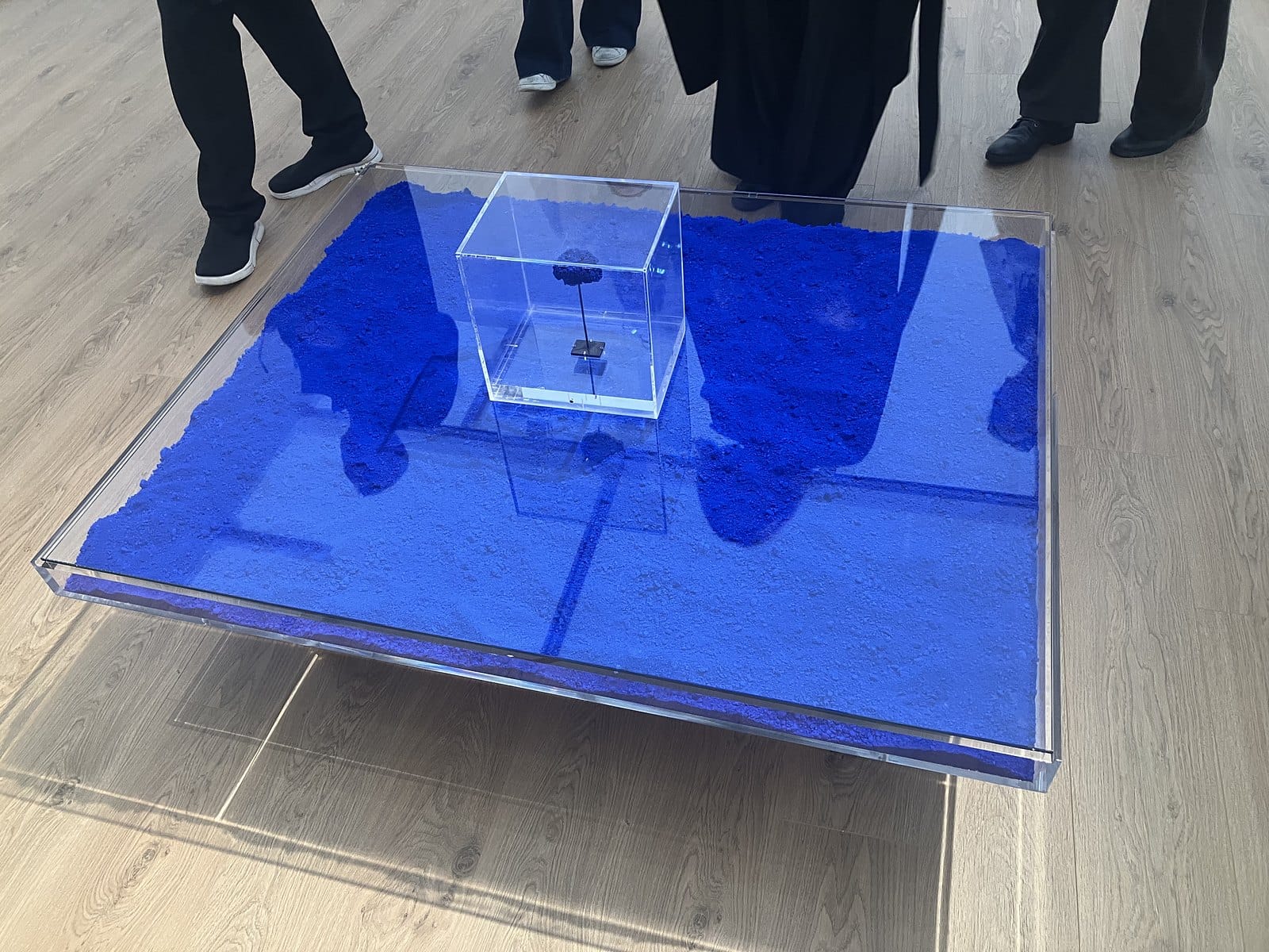 Yves Klein's low glass coffee table filled with bright blue pigment, a small cased sculpture on top