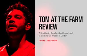 Armando Babaioff as Tom, lit in red against a black stage, beside the headline Tom at the Farm review