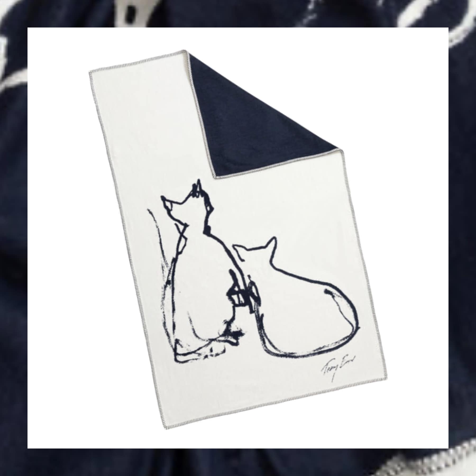 Cream recycled cotton blanket with navy line drawing of two cats and Tracey Emin signature, navy reverse side visible at corner.