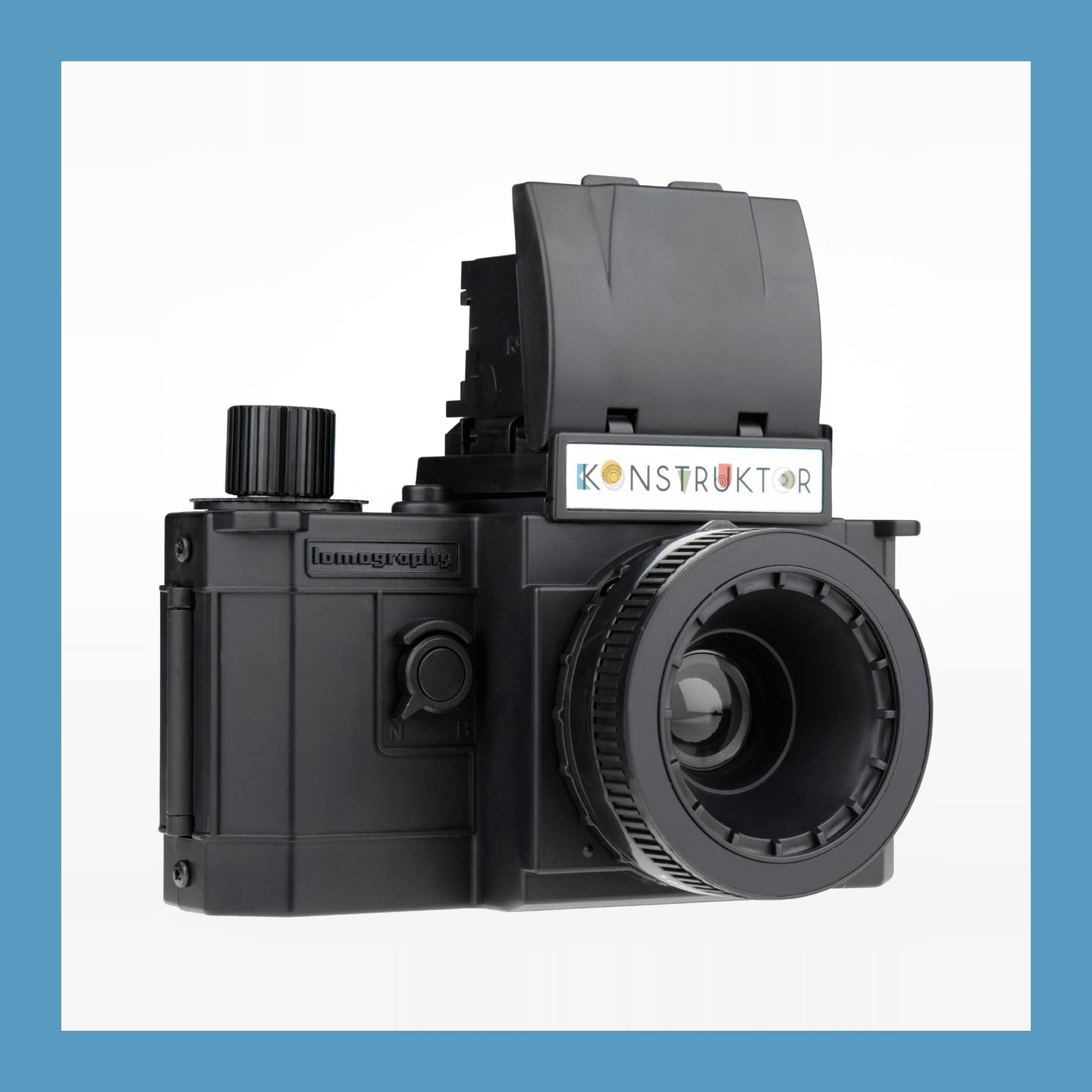 Lomography Konstruktor build-it-yourself 35mm SLR camera in black, viewfinder hood raised, on a white background