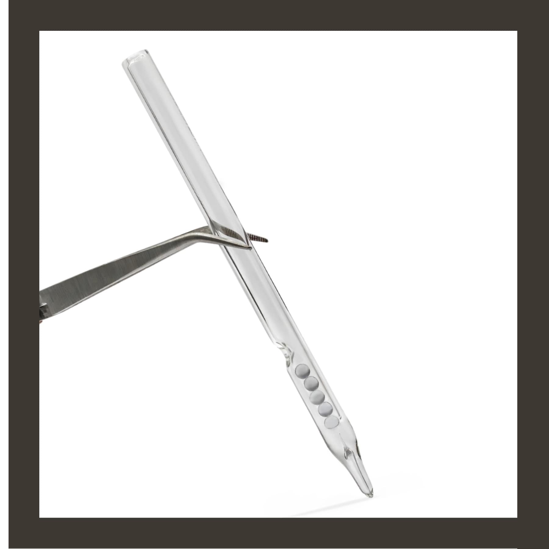 Requin Renard glass pen B1 held in forceps, showing the bevelled glass nib and five reservoir beads on white.