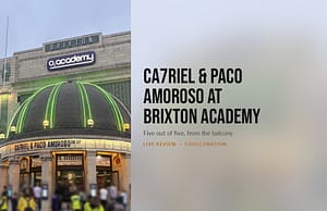 Split panel cover: the lit dome of O2 Academy Brixton beside the review headline.